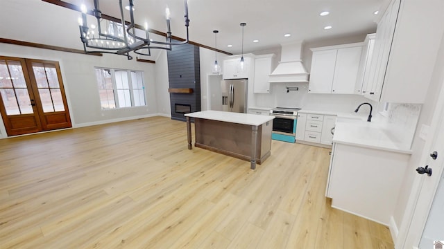 kitchen with a kitchen island, decorative light fixtures, white cabinetry, stainless steel appliances, and custom range hood
