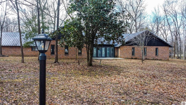 view of side of property featuring brick siding
