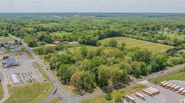 birds eye view of property with a view of trees