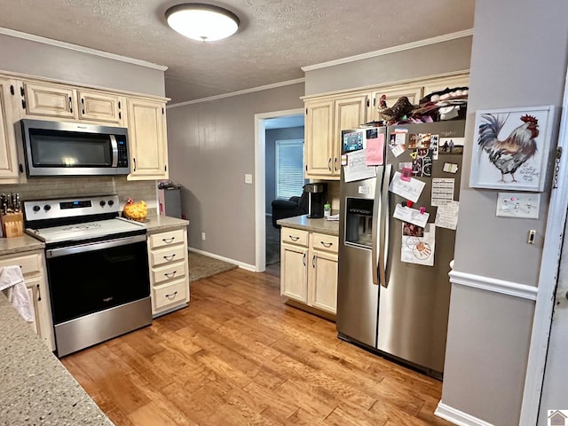 kitchen featuring light hardwood / wood-style flooring, stainless steel appliances, tasteful backsplash, cream cabinets, and ornamental molding