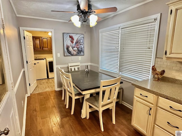 dining space with washing machine and clothes dryer, crown molding, a textured ceiling, hardwood / wood-style flooring, and ceiling fan