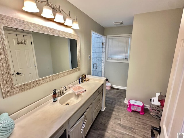 bathroom featuring hardwood / wood-style flooring and vanity