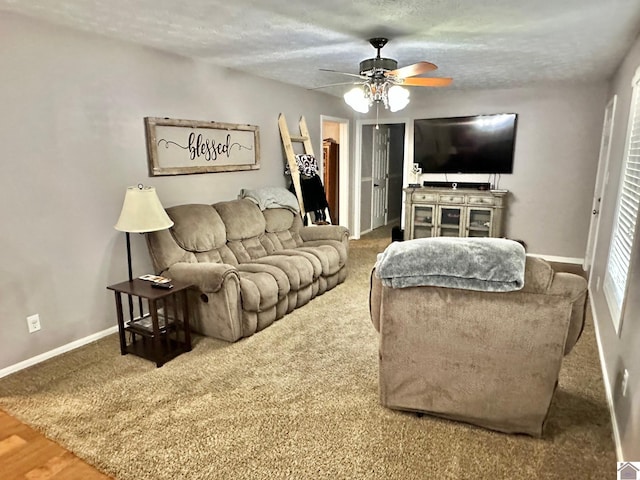 living room featuring a textured ceiling and ceiling fan