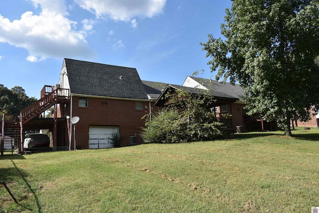 view of side of property with a garage and a lawn