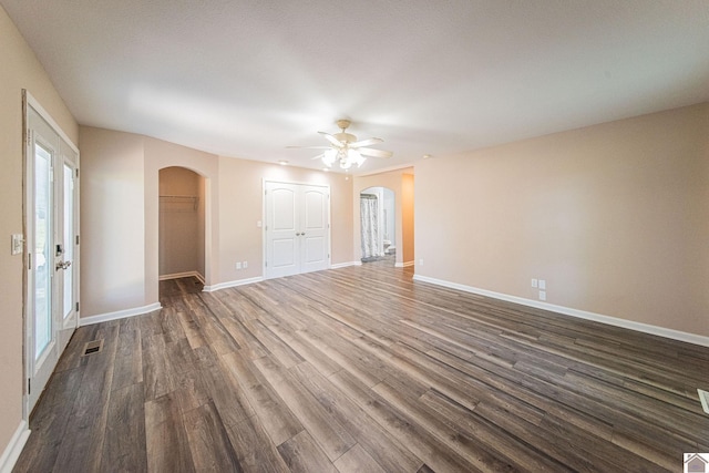 empty room featuring ceiling fan and dark hardwood / wood-style flooring