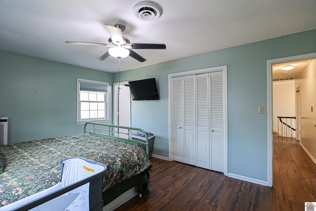 bedroom with dark hardwood / wood-style flooring, a closet, and ceiling fan