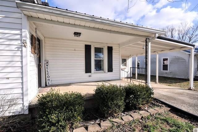 view of exterior entry with a porch