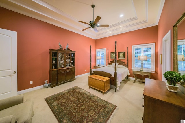 carpeted bedroom featuring a tray ceiling and crown molding