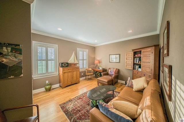 living room with crown molding and light hardwood / wood-style floors