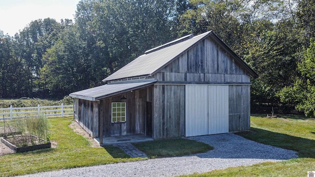 view of outbuilding with a lawn