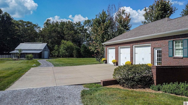 view of yard with a garage and an outdoor structure