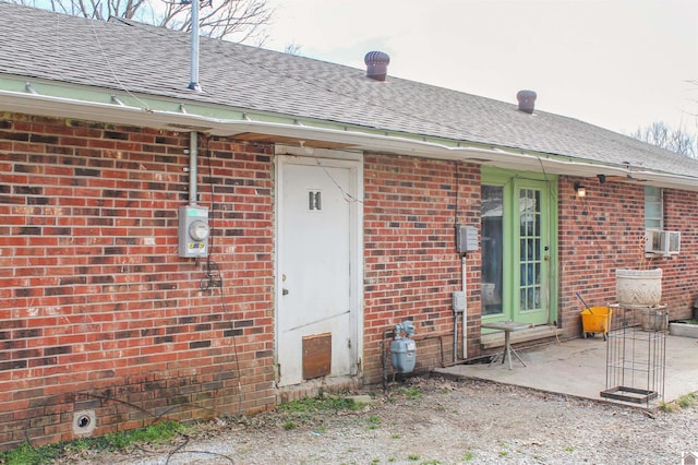 doorway to property with cooling unit and a patio area