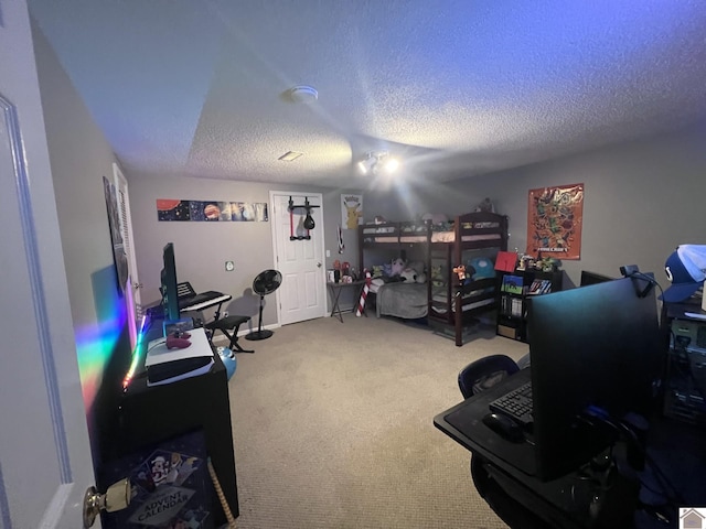 home office featuring carpet and a textured ceiling