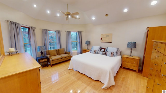 bedroom featuring ceiling fan, vaulted ceiling, and light hardwood / wood-style floors