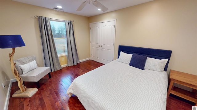 bedroom with ceiling fan, dark hardwood / wood-style floors, and a closet