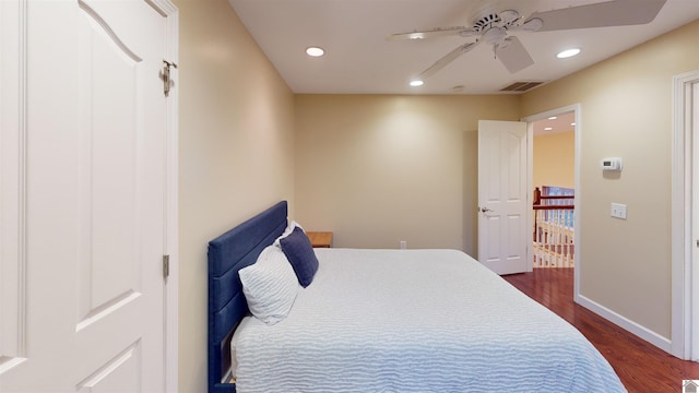 bedroom with ceiling fan and dark hardwood / wood-style flooring