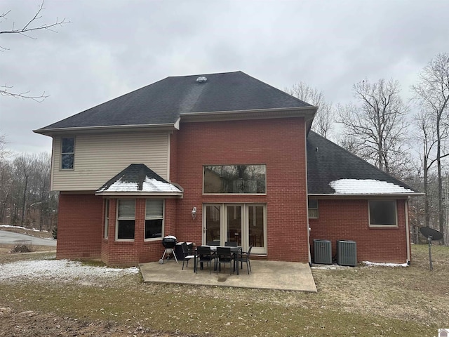 rear view of house featuring central AC, a patio, and a lawn