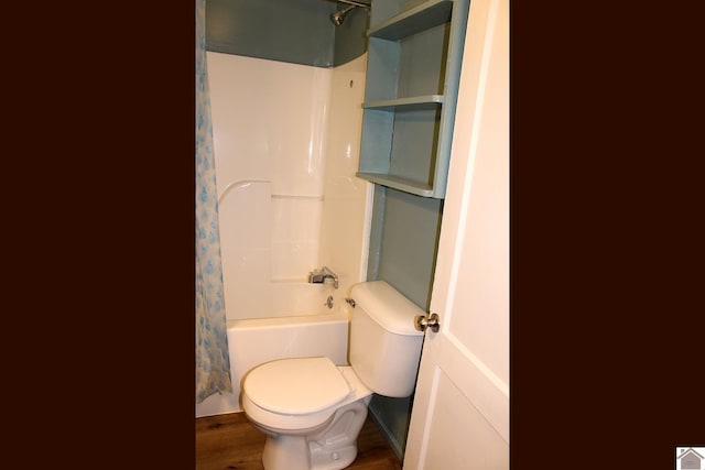 bathroom with shower / bath combo, hardwood / wood-style floors, and toilet