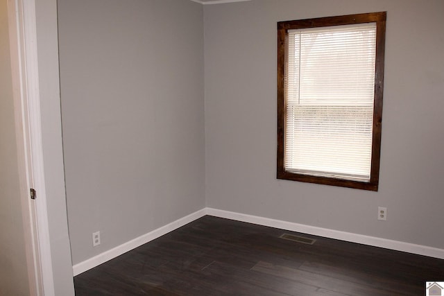 empty room with dark hardwood / wood-style floors