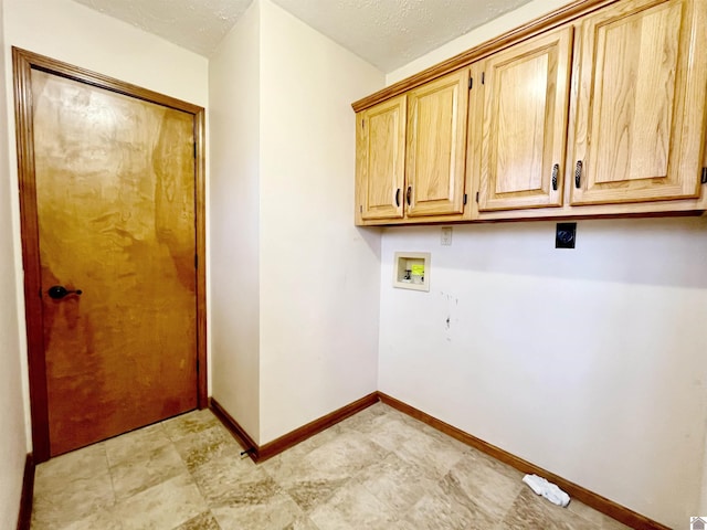 laundry room featuring cabinets, washer hookup, a textured ceiling, and electric dryer hookup