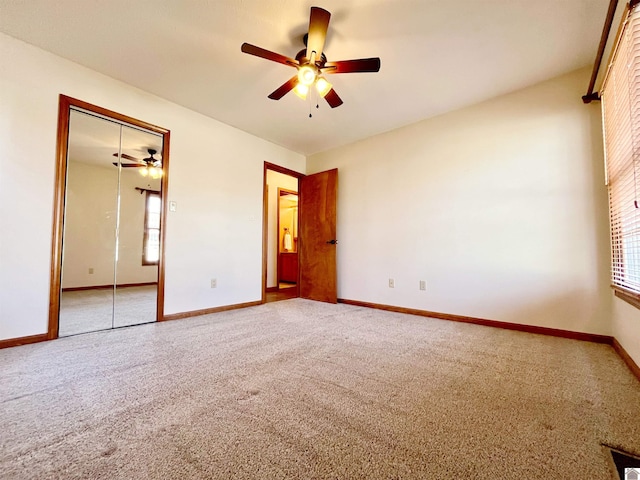 unfurnished bedroom featuring a closet, ceiling fan, and carpet flooring