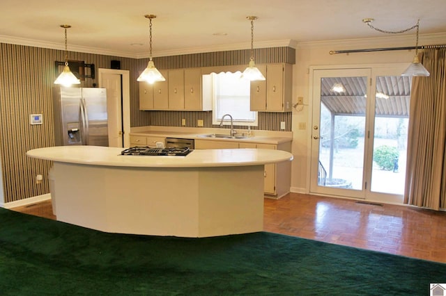 kitchen featuring appliances with stainless steel finishes, dark parquet flooring, pendant lighting, ornamental molding, and sink