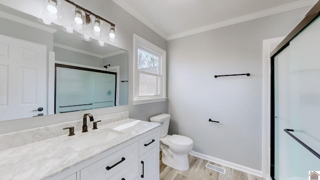 bathroom featuring crown molding, a shower with door, vanity, wood-type flooring, and toilet