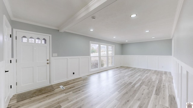 entryway featuring crown molding, beam ceiling, and light wood-type flooring