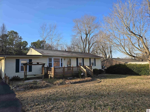 ranch-style home with a wooden deck and a front yard