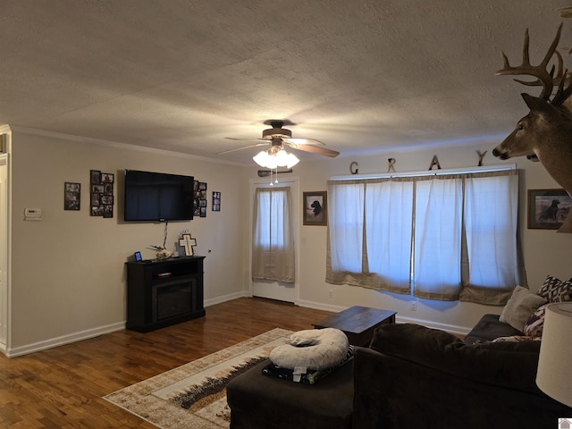 unfurnished living room featuring crown molding, ceiling fan, hardwood / wood-style flooring, and a textured ceiling