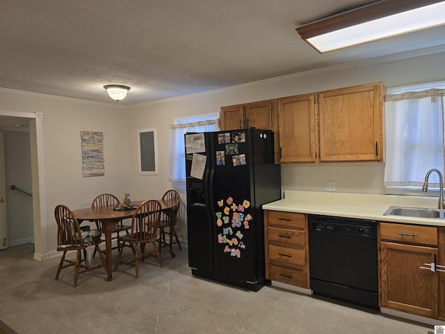 kitchen featuring ornamental molding, sink, a textured ceiling, and black appliances