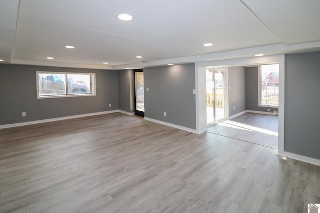 empty room featuring a healthy amount of sunlight and light wood-type flooring