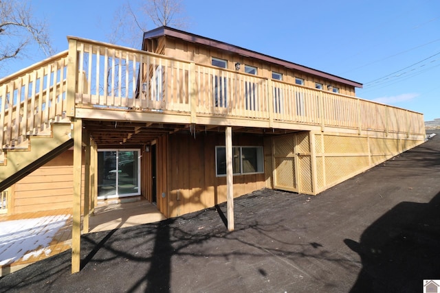 rear view of property featuring a wooden deck