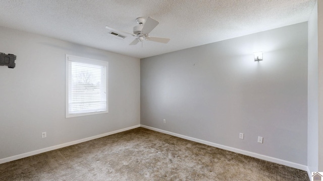 carpeted empty room with a textured ceiling and ceiling fan