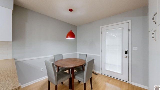 dining area with light hardwood / wood-style floors