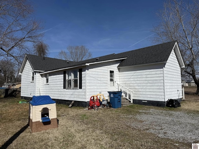 exterior space featuring a shingled roof and crawl space