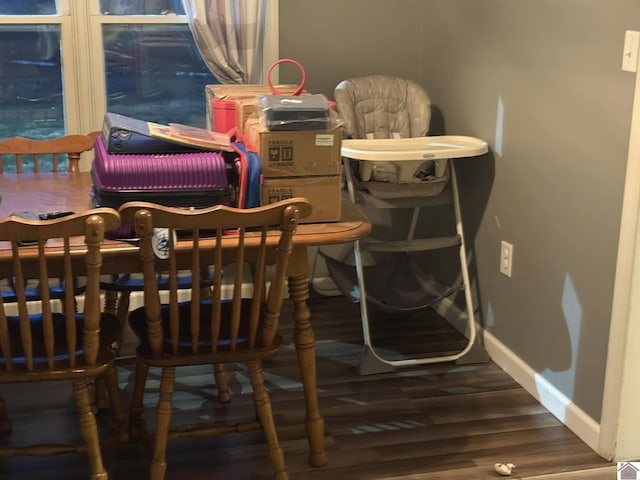 dining area with baseboards and wood finished floors