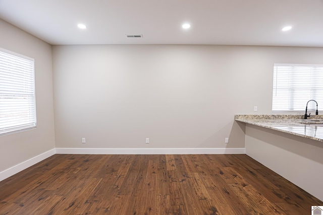 interior space featuring sink, dark hardwood / wood-style flooring, and a wealth of natural light