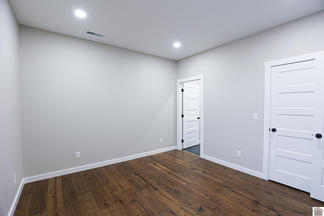 spare room featuring dark hardwood / wood-style floors