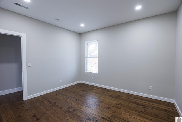 empty room with dark hardwood / wood-style floors