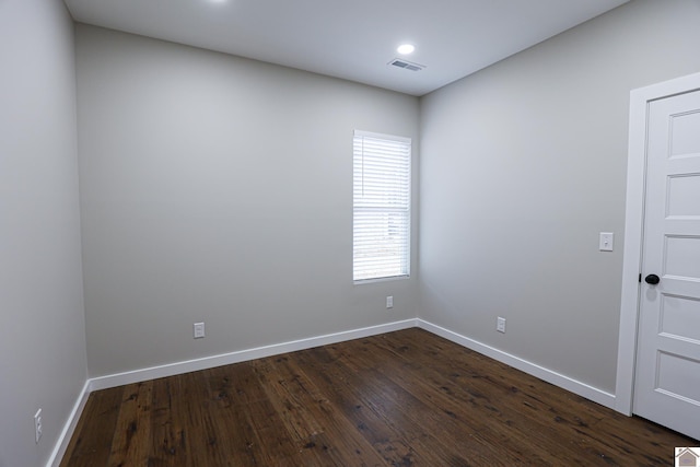 spare room featuring dark hardwood / wood-style floors