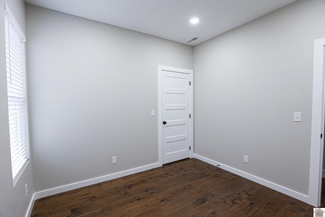 unfurnished room featuring dark wood-type flooring