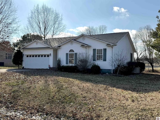 ranch-style home with a garage and a front lawn