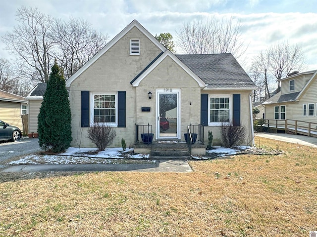 bungalow-style home featuring a front lawn