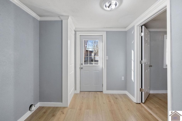 foyer entrance with light wood-type flooring and ornamental molding