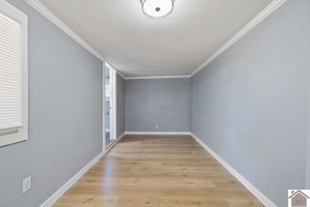 unfurnished room with a textured ceiling, crown molding, and light hardwood / wood-style flooring