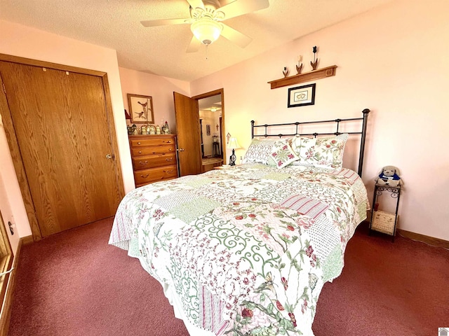 bedroom featuring a textured ceiling, ceiling fan, a closet, and dark carpet