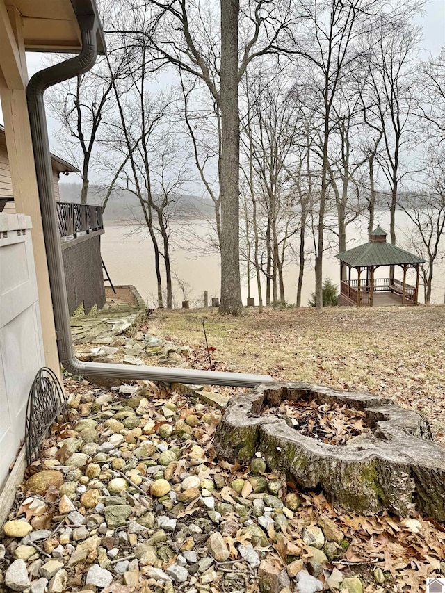 view of yard featuring a gazebo and a water view