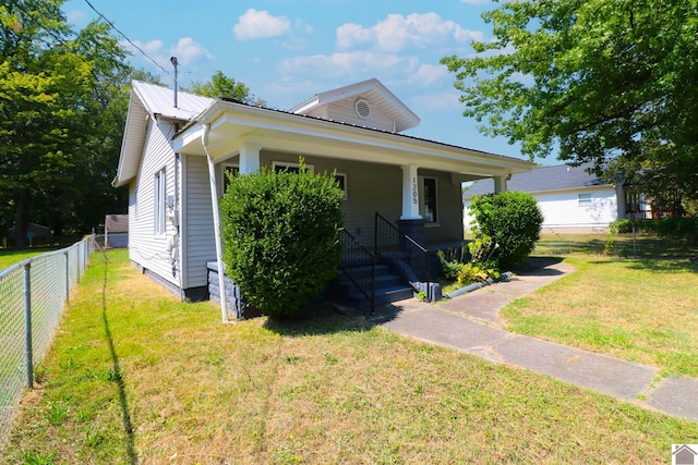 bungalow with a front lawn and a porch