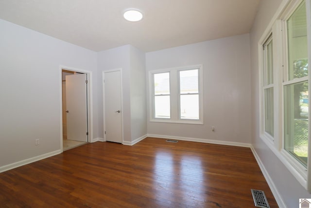 unfurnished room featuring dark hardwood / wood-style flooring